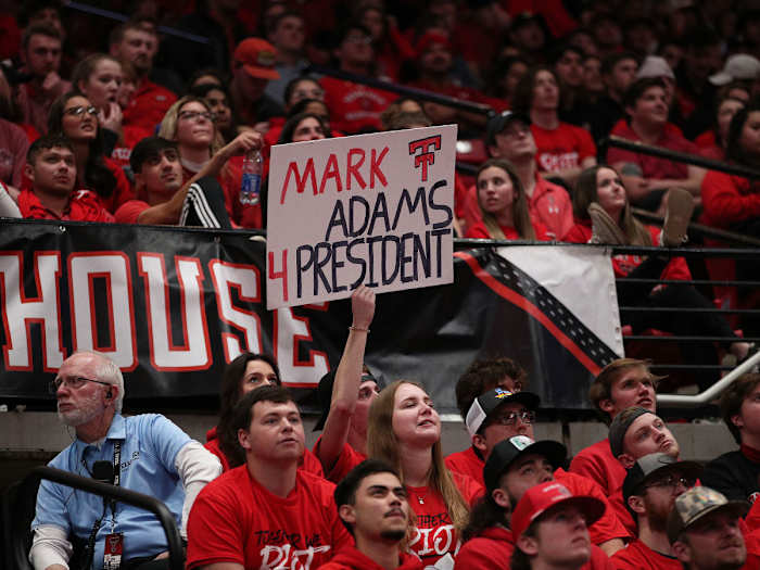 Texas Tech fans hold a "Mark Adams 4 President" sign